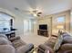 Spacious living room with comfortable sofas and large TV at 409 Silver Maple Rd, Groveland, FL 34736