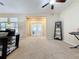 Carpeted living room with french doors and built-in shelving at 409 Silver Maple Rd, Groveland, FL 34736