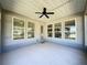 Covered patio with ceiling fan and windows at 409 Silver Maple Rd, Groveland, FL 34736