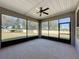 Spacious screened patio with ceiling fan and backyard view at 409 Silver Maple Rd, Groveland, FL 34736