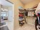 Spacious walk-in closet with shelving and hanging rods at 409 Silver Maple Rd, Groveland, FL 34736