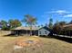 Home's backyard with fire pit and screened porch at 41913 Cassia St, Eustis, FL 32736