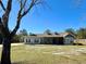 Single story home with gray siding, covered porch, and landscaped lawn at 41913 Cassia St, Eustis, FL 32736