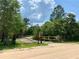 Entrance to the property with a rustic wooden gate at 41913 Cassia St, Eustis, FL 32736