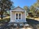 Tan workshop with double doors and covered porch at 41913 Cassia St, Eustis, FL 32736