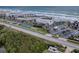 Aerial view showing oceanfront condo complex with tennis courts at 4870 S. Atlantic Ave, # 2040, New Smyrna Beach, FL 32169