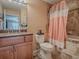 Bathroom with peach shower curtain and granite countertop at 4870 S. Atlantic Ave, # 2040, New Smyrna Beach, FL 32169