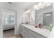 Double vanity bathroom with a large shower and tile flooring at 4992 Big Cypress St, Oxford, FL 34484