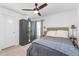 Cozy bedroom featuring a ceiling fan and gray bedding at 4992 Big Cypress St, Oxford, FL 34484