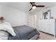 Bright bedroom with ceiling fan, gray bedding, and built-in storage at 4992 Big Cypress St, Oxford, FL 34484