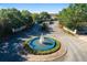 Circular entrance to community with fountain and landscaping at 4992 Big Cypress St, Oxford, FL 34484