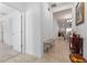 Bright and airy foyer with tile flooring and a bench at 4992 Big Cypress St, Oxford, FL 34484