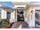 Front entry with a screened door and brick walkway at 4992 Big Cypress St, Oxford, FL 34484