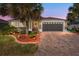 Well-maintained house with a gray garage door and landscaped yard at 4992 Big Cypress St, Oxford, FL 34484