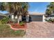 House exterior showcasing a brick driveway and palm trees at 4992 Big Cypress St, Oxford, FL 34484