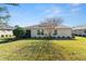 Single-story house with light-colored siding and a neatly landscaped lawn at 4992 Big Cypress St, Oxford, FL 34484