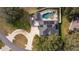 An aerial view showing the home's pool, solar panels, and a large backyard with landscaping at 5055 County Road 125 # B1, Wildwood, FL 34785