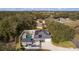 Aerial view of a house with pool and solar panels, showcasing large backyard and driveway at 5055 County Road 125 # B1, Wildwood, FL 34785