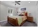 Cozy bedroom with wood bed frame and window shutters at 5055 County Road 125 # B1, Wildwood, FL 34785