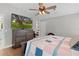 Bedroom with large TV, dresser, and window at 5055 County Road 125 # B1, Wildwood, FL 34785