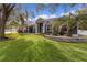 Gray house exterior with stone wall and lush landscaping at 5055 County Road 125 # B1, Wildwood, FL 34785