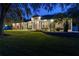 Gray house exterior with landscaping, illuminated at night at 5055 County Road 125 # B1, Wildwood, FL 34785