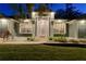 Gray house exterior with white columns, illuminated at night at 5055 County Road 125 # B1, Wildwood, FL 34785