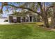 Gray house exterior with large oak tree and manicured lawn at 5055 County Road 125 # B1, Wildwood, FL 34785