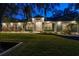 Gray house exterior with landscaping, illuminated at night at 5055 County Road 125 # B1, Wildwood, FL 34785