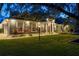 Gray house exterior with landscaping, illuminated at night at 5055 County Road 125 # B1, Wildwood, FL 34785