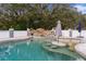 Kidney shaped swimming pool with a waterfall feature at 5055 County Road 125 # B1, Wildwood, FL 34785