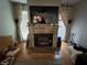 Living room fireplace with granite surround and large TV at 509 Jackson St, Eustis, FL 32726