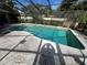 Inviting kidney-shaped swimming pool with screened enclosure at 509 Jackson St, Eustis, FL 32726