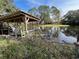 Wooden boathouse on a calm lake with canoe and dock at 509 Jackson St, Eustis, FL 32726