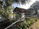 Covered dock with a canoe on a calm body of water at 509 Jackson St, Eustis, FL 32726