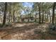 View of backyard with mature trees and spacious lot at 5870 Se 158Th Ct, Ocklawaha, FL 32179