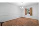 Empty dining room with brown carpet and a window with curtains at 5938 Marlberry Dr, Orlando, FL 32819