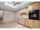 View of kitchen with light wood cabinets and black appliances at 5938 Marlberry Dr, Orlando, FL 32819