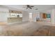 Open living room with kitchen bar and view of staircase at 5938 Marlberry Dr, Orlando, FL 32819