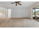 Large living room with stained carpet and ceiling fan at 5938 Marlberry Dr, Orlando, FL 32819