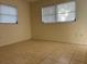 Well-lit bedroom with tile floors and neutral walls at 609 Scenic St, Leesburg, FL 34748