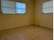 Spacious bedroom with tile floors and neutral walls at 609 Scenic St, Leesburg, FL 34748