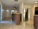 Kitchen with stainless steel refrigerator and breakfast bar at 609 Scenic St, Leesburg, FL 34748