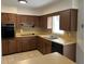 Bright kitchen features wood cabinets, tile floors, and stainless steel appliances at 609 Scenic St, Leesburg, FL 34748