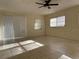 Spacious living room featuring tile floors and a ceiling fan at 609 Scenic St, Leesburg, FL 34748