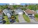 Aerial view of a single-story home with a long driveway and mature trees at 7 Ginger Cir, Leesburg, FL 34748