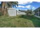 Green backyard with storage shed at 7 Ginger Cir, Leesburg, FL 34748