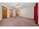 Spacious bedroom featuring plush carpet and a lighted ceiling fan for added comfort at 7 Ginger Cir, Leesburg, FL 34748