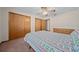 This bedroom features a ceiling fan and large closet at 7 Ginger Cir, Leesburg, FL 34748
