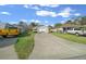 Long concrete driveway leads to an attached one-car garage at 7 Ginger Cir, Leesburg, FL 34748